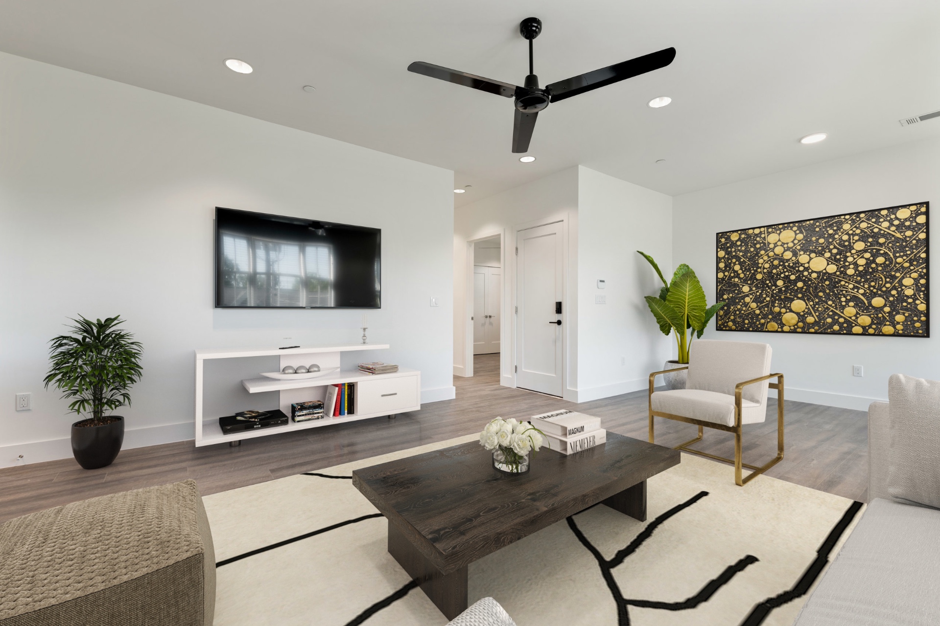 Unit 4-2 living room with mounted TV and accent art